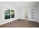 Bright living room featuring hardwood floors and built-in shelving at 18925 3Rd Ave, Orlando, FL 32820