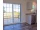 Kitchen with sliding glass doors leading to a deck, stainless steel appliances, and wood-style flooring at 129 Constitution Ln, Frostproof, FL 33843