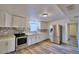 Updated kitchen with white cabinets, hex tile backsplash, and stainless steel appliances at 3401 Avenue V Nw, Winter Haven, FL 33881