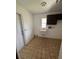 Laundry room with utility sink and built-in shelving at 4422 Meadowood St, Orlando, FL 32812