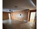 Living room with wood paneled walls and concrete floors at 4422 Meadowood St, Orlando, FL 32812