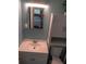 Clean bathroom with a modern vanity, mirror, and storage cabinet at 3110 Port Royal Dr, Orlando, FL 32827