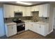 Modern kitchen featuring white shaker cabinets, stainless steel appliances, and updated backsplash at 7204 Peyton Pl, Orlando, FL 32818