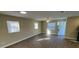 Bright and spacious living room with wood-look flooring and ample natural light at 7204 Peyton Pl, Orlando, FL 32818