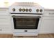 Modern white kitchen stove with gold-colored burner controls at 1632 E Ridgewood St, Orlando, FL 32803