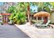 Relaxing patio area with lounge chairs and tropical plants at 24120 Mink Rd, Astor, FL 32102