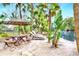 Relaxing patio area with picnic table, lounge chairs, and umbrella, overlooking a canal at 24120 Mink Rd, Astor, FL 32102