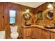 Charming bathroom with double sinks, wood details, and nautical accents at 24120 Mink Rd, Astor, FL 32102