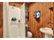 Small bathroom with shower, toilet, and a unique porthole window at 24120 Mink Rd, Astor, FL 32102