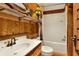 Clean bathroom with a tub, sink, and wood-paneled walls at 24120 Mink Rd, Astor, FL 32102