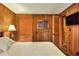 Simple bedroom with wood walls, a double bed, and built-in closet at 24120 Mink Rd, Astor, FL 32102