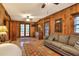 Relaxing bedroom with wood paneled walls and access to a private patio at 24120 Mink Rd, Astor, FL 32102