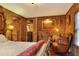 Cozy bedroom with wood paneling, comfortable seating, and unique decor at 24120 Mink Rd, Astor, FL 32102