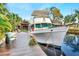 Spacious wooden dock with a classic boat and seating area at 24120 Mink Rd, Astor, FL 32102