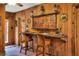 Rustic breakfast bar with wooden bar stools and unique wall decor at 24120 Mink Rd, Astor, FL 32102