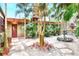 Peaceful courtyard oasis with stone pathway, fountain, and lush landscaping at 24120 Mink Rd, Astor, FL 32102
