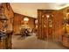 Charming dining room with wood walls and a unique wooden door at 24120 Mink Rd, Astor, FL 32102