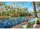 Serene waterfront dock with seating and beautiful water views at 24120 Mink Rd, Astor, FL 32102