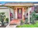 Inviting front door with stone accents and terracotta tile at 24120 Mink Rd, Astor, FL 32102