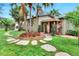 Landscaped front yard with stone path and lush greenery at 24120 Mink Rd, Astor, FL 32102