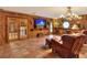 Game room with a built-in bar, comfortable leather seating, and a large flat-screen TV at 24120 Mink Rd, Astor, FL 32102