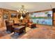 Spacious garage with painted mural, leather seating, and tile floor at 24120 Mink Rd, Astor, FL 32102