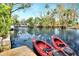 Two red kayaks on a dock overlooking a calm waterway at 24120 Mink Rd, Astor, FL 32102