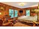 Relaxing main bedroom with leather chairs and wood-framed bed at 24120 Mink Rd, Astor, FL 32102