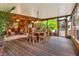 Outdoor dining area on a large screened porch at 24120 Mink Rd, Astor, FL 32102