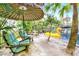Charming waterfront patio with comfortable seating and umbrella, overlooking the calm water at 24120 Mink Rd, Astor, FL 32102