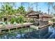 Picturesque canal view with a boat and lush landscaping at 24120 Mink Rd, Astor, FL 32102