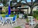 Outdoor kitchen with grill and patio furniture at 3800 Saxon Dr # C-52, New Smyrna Beach, FL 32169