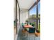Outdoor balcony with patio furniture and lush greenery at 3800 Saxon Dr # C-52, New Smyrna Beach, FL 32169