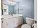Updated bathroom with white vanity and blue walls at 3800 Saxon Dr # C-52, New Smyrna Beach, FL 32169