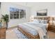 Spacious bedroom with light wood furniture and window at 3800 Saxon Dr # C-52, New Smyrna Beach, FL 32169