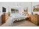 Main bedroom with wood furniture and large window at 3800 Saxon Dr # C-52, New Smyrna Beach, FL 32169