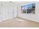Bright bedroom with neutral carpeting, double closets and large window at 3800 Saxon Dr # C-52, New Smyrna Beach, FL 32169