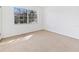 Empty carpeted bedroom with large window at 3800 Saxon Dr # C-52, New Smyrna Beach, FL 32169