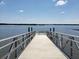 Wooden pier extending over the water with bench at 3800 Saxon Dr # C-52, New Smyrna Beach, FL 32169