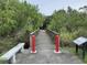 Wooden footbridge with red posts and bench at 3800 Saxon Dr # C-52, New Smyrna Beach, FL 32169