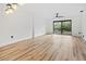 Living room with hardwood floors, sliding doors to balcony at 3800 Saxon Dr # C-52, New Smyrna Beach, FL 32169