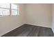 Bright bedroom with window, dark gray flooring, and built-in closet at 260 Avenue V Ne, Winter Haven, FL 33881