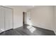 Bedroom with grey vinyl flooring, fresh paint, and built-in closet at 260 Avenue V Ne, Winter Haven, FL 33881