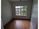 Bright bedroom with hardwood floors and large window at 2721 Woodland Hills Ave, Lakeland, FL 33803