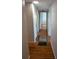 Long hallway with hardwood floors and doors to bedrooms at 2721 Woodland Hills Ave, Lakeland, FL 33803