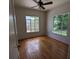 Spacious bedroom with hardwood floors and two windows at 2721 Woodland Hills Ave, Lakeland, FL 33803