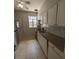 Galley kitchen with white cabinets and granite counters at 2721 Woodland Hills Ave, Lakeland, FL 33803