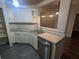Modern kitchen with white cabinets, granite countertops, and stainless steel dishwasher at 6059 Magpie Dr, Lakeland, FL 33809