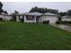 Single-story house with green lawn and attached garage at 6059 Magpie Dr, Lakeland, FL 33809