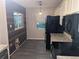 Kitchen with black appliances and wood-look flooring at 6059 Magpie Dr, Lakeland, FL 33809